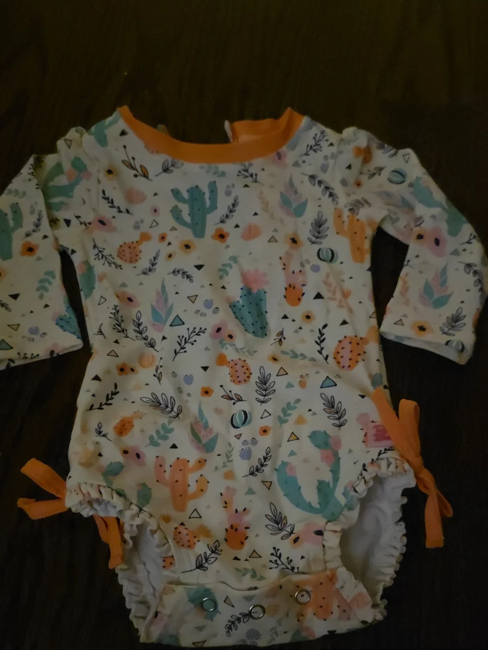 Ruffle Butts White Cactus Floral Long-Sleeve One-Piece with Orange Trim